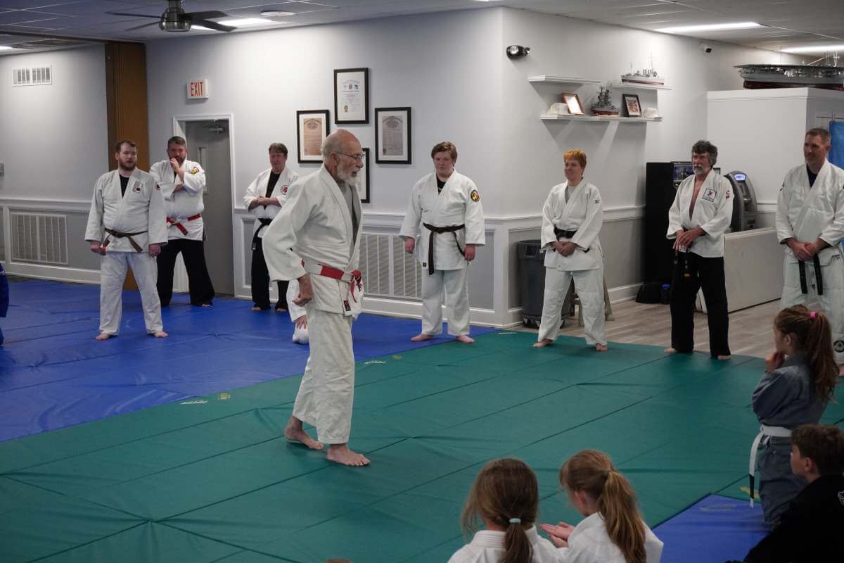 Sensei David Boesel (center) talking about the importance of maintaining your balance.