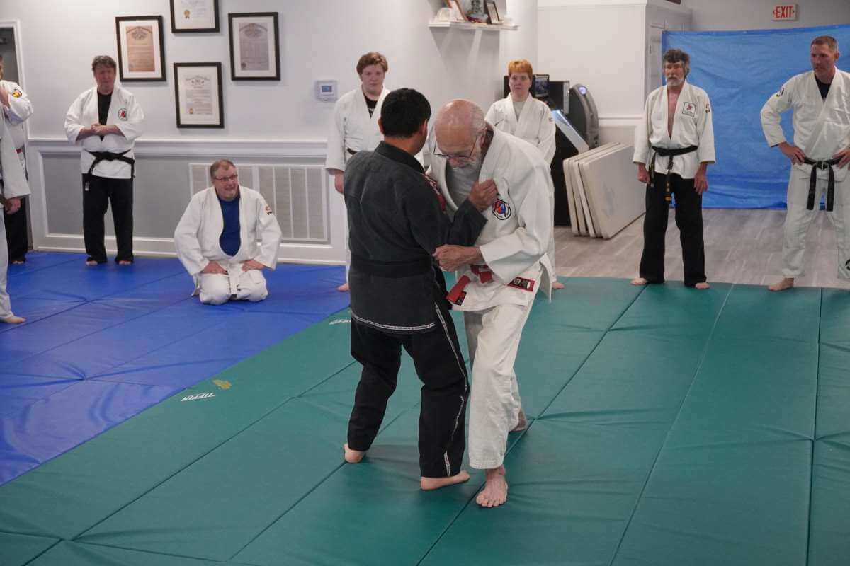 Sensei David Boesel (right) demonstrating the step involved in taking balance away but going hip to hip with Young Kim (Left).